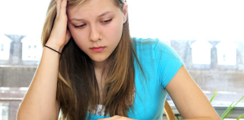 Teenage Girl Studying With Textbooks Teenage girl studying with textbooks looking unhappy